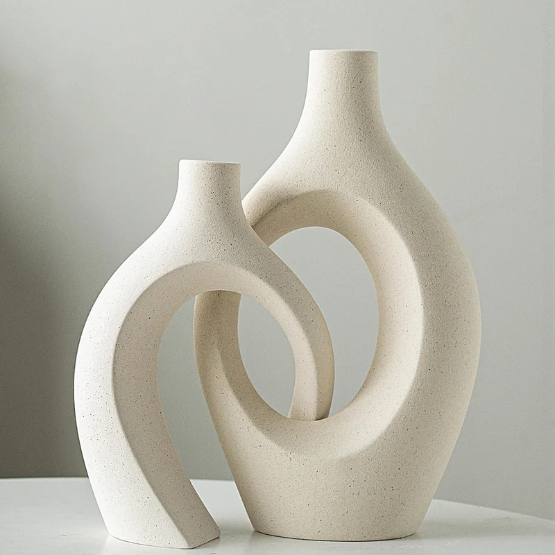 Levvohd Beige Ceramic Hollow Vases: sculptural cream vases. pretty with or without flowers.